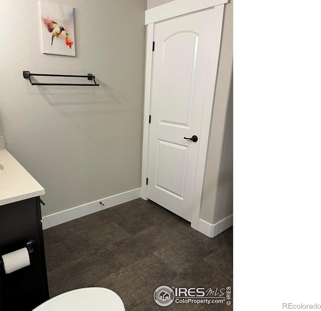 bathroom featuring baseboards and vanity
