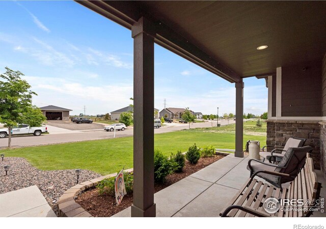 5063 Prairie Lark Ln, Severance, CO 80615 - covered porch featuring a lawn