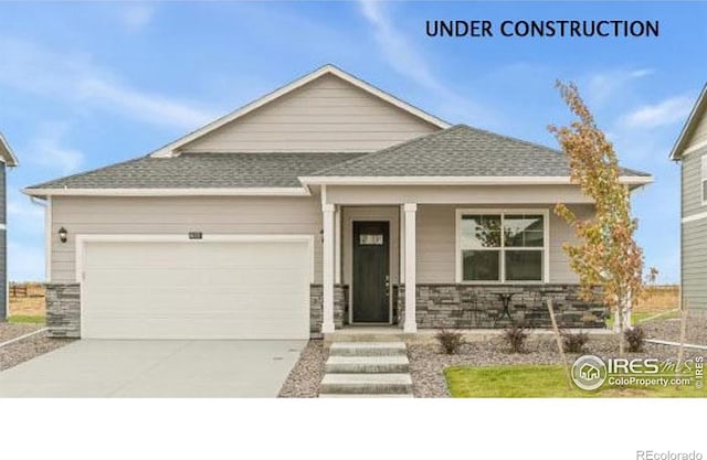 2727 73rd Ave, Greeley, CO 80634 - craftsman-style home featuring an attached garage, concrete driveway, stone siding, and a porch