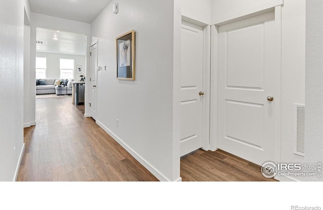 2727 73rd Ave, Greeley, CO 80634 - corridor featuring wood finished floors and baseboards
