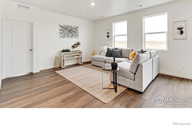 2727 73rd Ave, Greeley, CO 80634 - living area featuring wood finished floors and baseboards