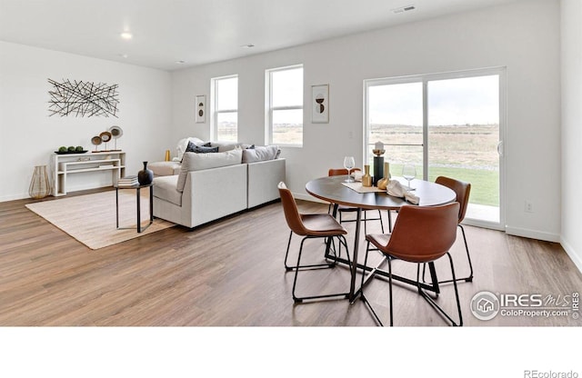 2727 73rd Ave, Greeley, CO 80634 - dining room featuring wood finished floors, baseboards, and recessed lighting