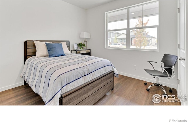 2727 73rd Ave, Greeley, CO 80634 - bedroom with baseboards and wood finished floors