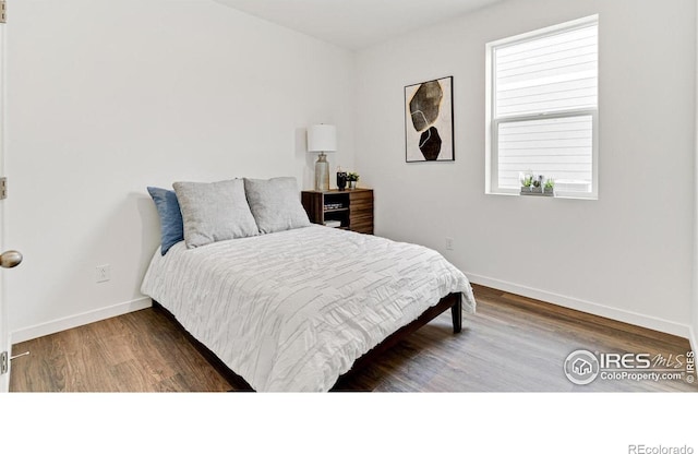 2727 73rd Ave, Greeley, CO 80634 - bedroom with baseboards and wood finished floors