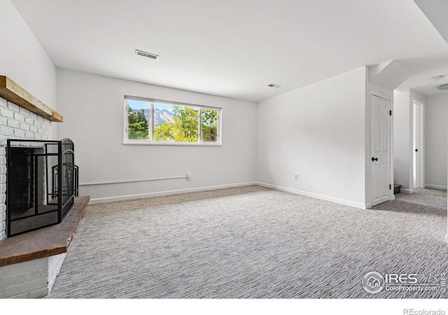 1350 Lehigh St, Boulder, CO 80305 - unfurnished living room with carpet flooring, a brick fireplace, and baseboards