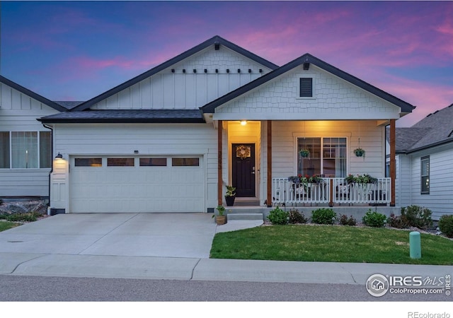 3593 Taylor Walker St, Loveland, CO 80537 - view of front facade featuring a porch, a garage, board and batten siding, driveway, and a lawn