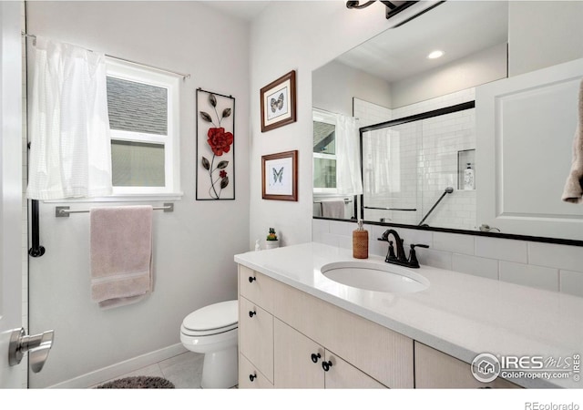 3593 Taylor Walker St, Loveland, CO 80537 - bathroom with toilet, a tile shower, vanity, tile patterned floors, and baseboards