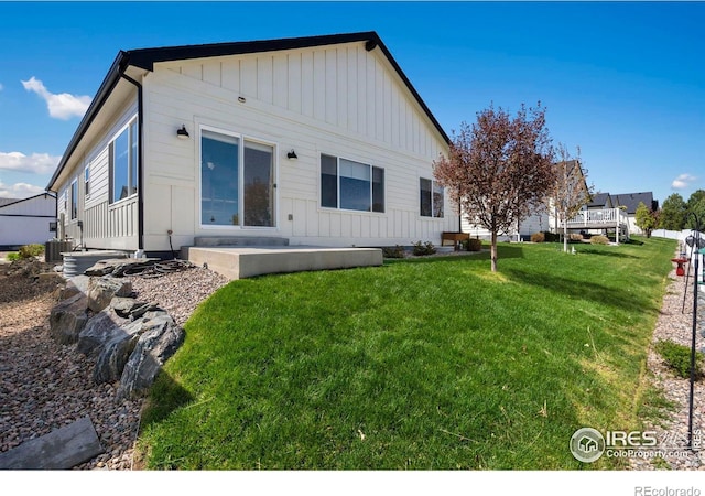 3593 Taylor Walker St, Loveland, CO 80537 - back of property featuring board and batten siding and a yard