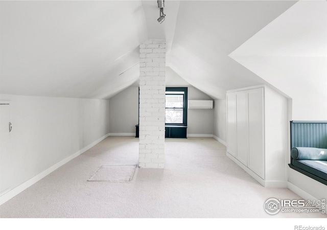 2424 4th St, Boulder, CO 80304 - additional living space featuring an AC wall unit, carpet, decorative columns, and vaulted ceiling
