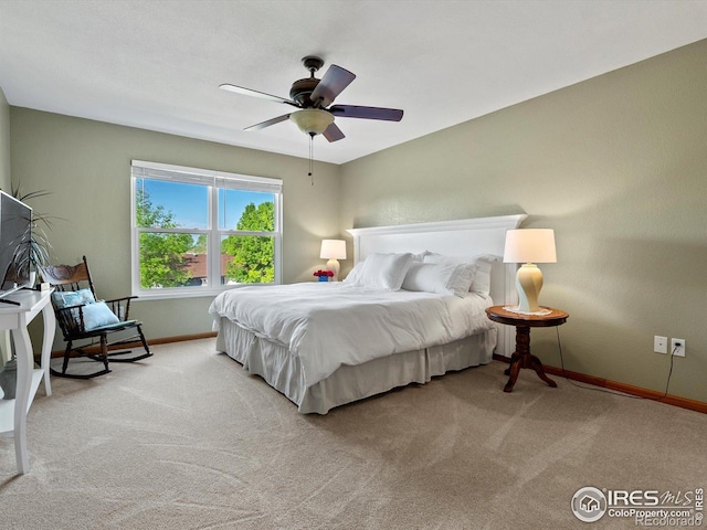 carpeted bedroom with baseboards and a ceiling fan