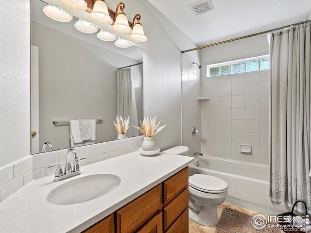 bathroom featuring shower / bath combo with shower curtain, toilet, and vanity
