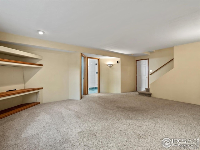 finished below grade area featuring carpet and stairway