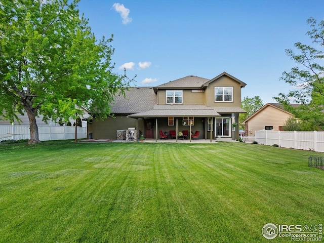 rear view of property featuring a patio area and roof with shingles