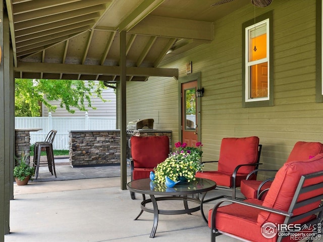 view of patio with fence and an outdoor kitchen
