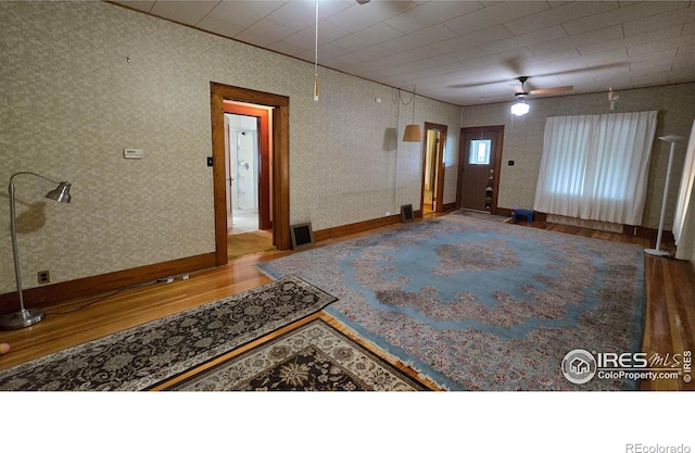 entryway featuring wood finished floors, baseboards, and a ceiling fan