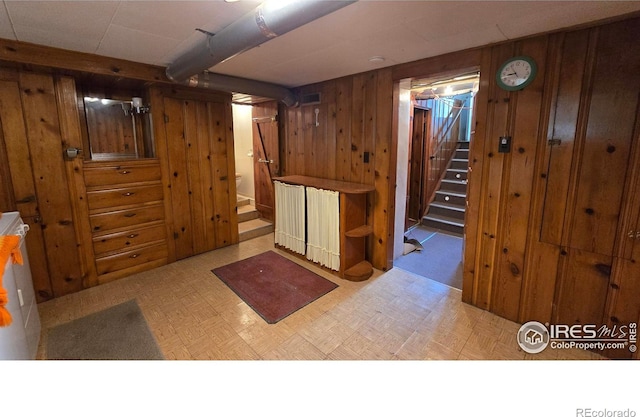 finished below grade area with stairs and wood walls