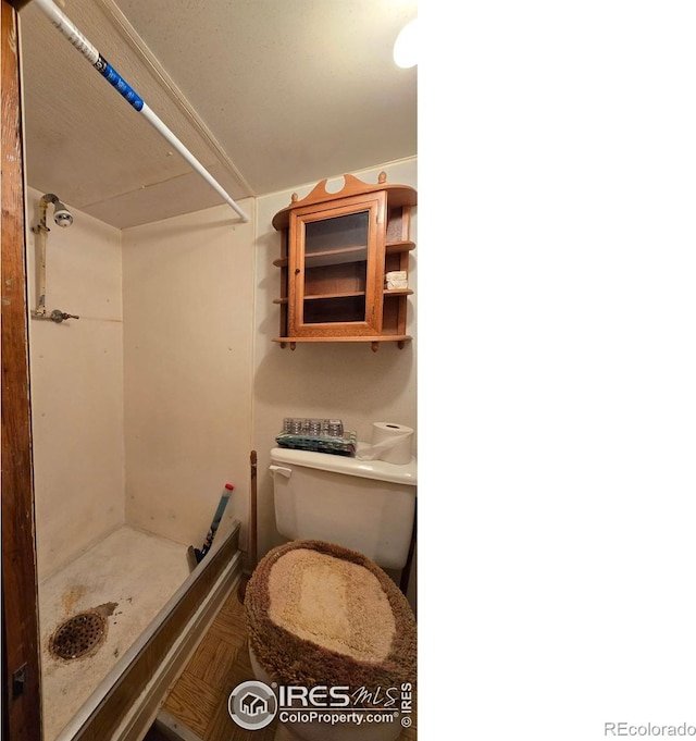 full bathroom featuring a stall shower and toilet