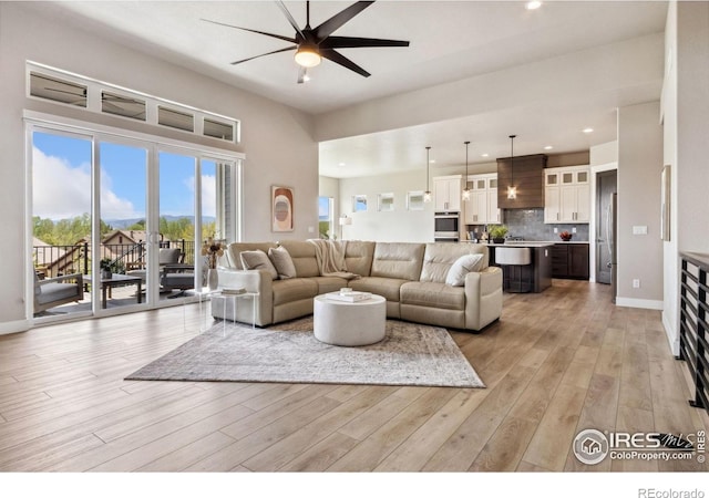 1721 Brightwater Dr, Fort Collins, CO 80524 - living room with ceiling fan, light wood-style floors, recessed lighting, and baseboards