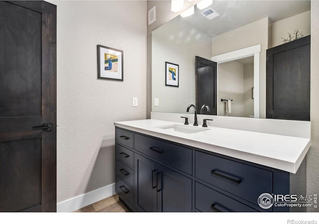1721 Brightwater Dr, Fort Collins, CO 80524 - bathroom featuring vanity, a textured wall, and baseboards
