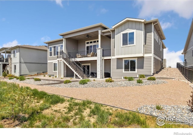 1721 Brightwater Dr, Fort Collins, CO 80524 - rear view of house featuring a ceiling fan, board and batten siding, stairway, and fence