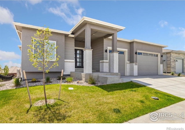 1721 Brightwater Dr, Fort Collins, CO 80524 - view of front facade with a garage, driveway, a front lawn, and stucco siding