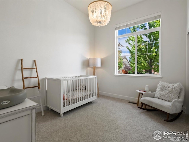 950 Sumner Way, Erie, CO 80516 - carpeted bedroom with a chandelier, baseboards, and a nursery area