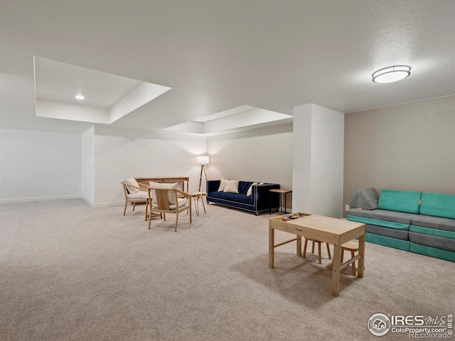 950 Sumner Way, Erie, CO 80516 - living area with carpet floors, a tray ceiling, and baseboards