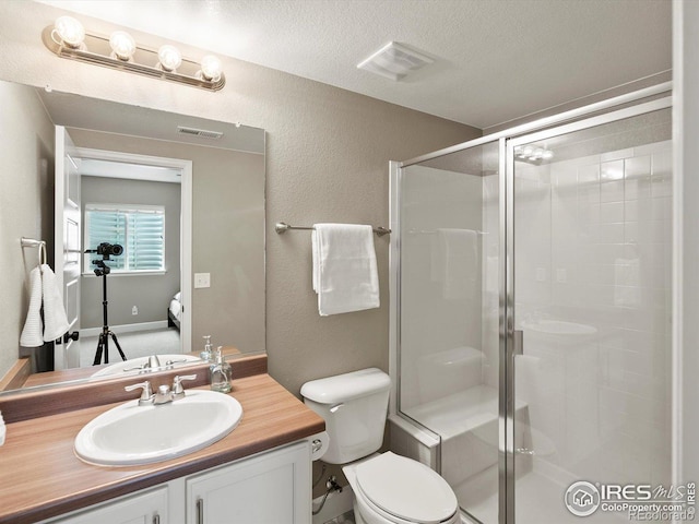 950 Sumner Way, Erie, CO 80516 - full bath with a stall shower, toilet, vanity, a textured ceiling, and a textured wall