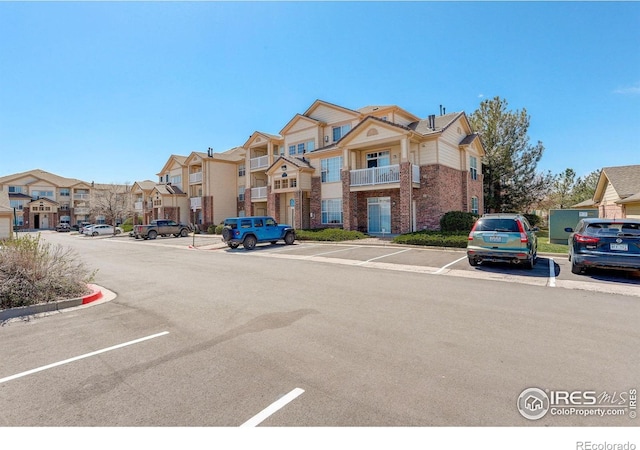 5723 N Gibralter Way Unit 205, Aurora, CO 80019 - view of asphalt street with curbs and a residential view