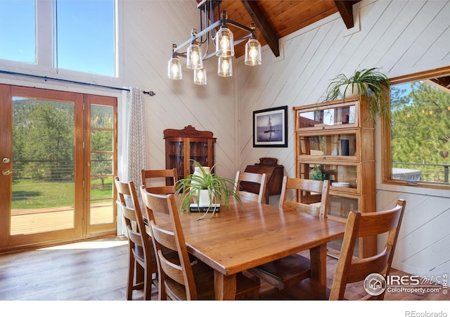 40 Hopi Ct, Lyons, CO 80540 - dining area with wood finished floors, beam ceiling, wood ceiling, wooden walls, and a chandelier