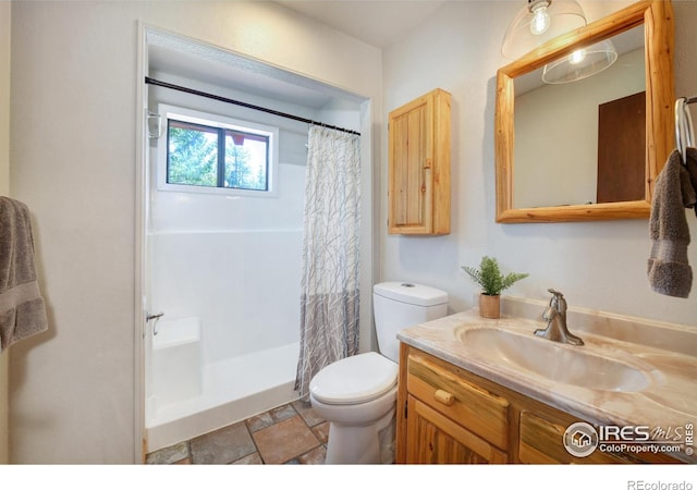 40 Hopi Ct, Lyons, CO 80540 - bathroom featuring toilet, a shower with shower curtain, vanity, and stone finish floors
