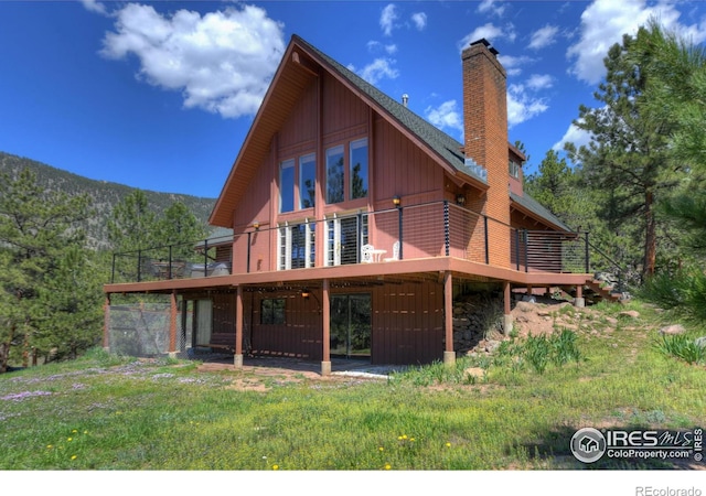 40 Hopi Ct, Lyons, CO 80540 - rear view of house featuring a chimney and a deck with mountain view