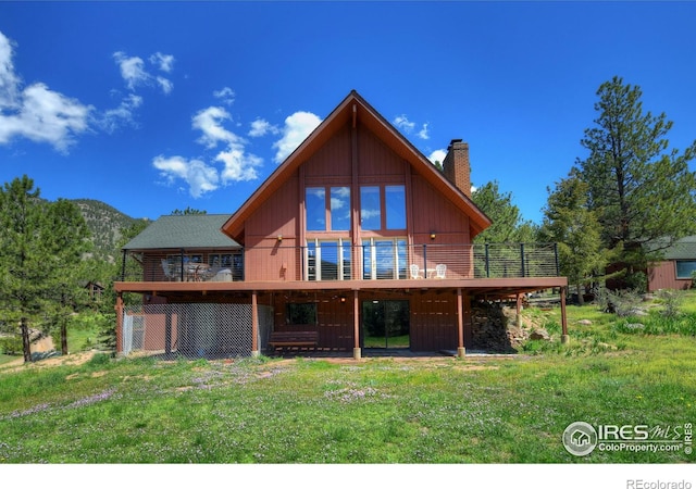 40 Hopi Ct, Lyons, CO 80540 - back of property featuring a deck, a chimney, and a lawn