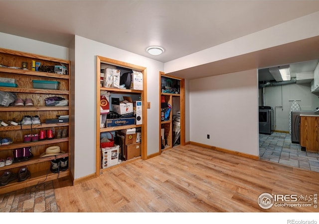 40 Hopi Ct, Lyons, CO 80540 - below grade area featuring wood finished floors, baseboards, and washer and dryer