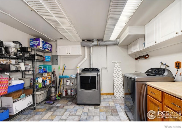 40 Hopi Ct, Lyons, CO 80540 - clothes washing area featuring separate washer and dryer, cabinet space, light stone finish floors, and electric panel