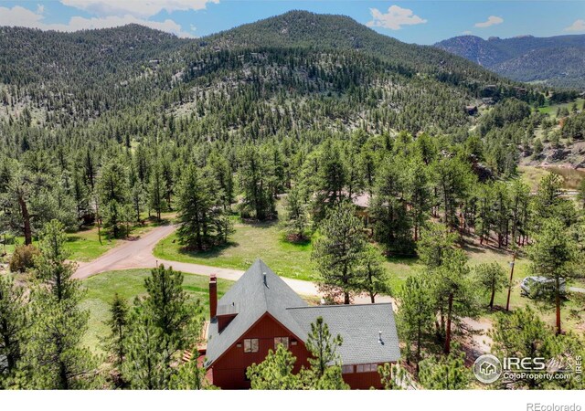 40 Hopi Ct, Lyons, CO 80540 - aerial view of property and surrounding area with a mountain backdrop and a heavily wooded area
