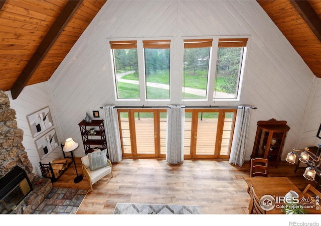 40 Hopi Ct, Lyons, CO 80540 - living room featuring light wood finished floors, healthy amount of natural light, beamed ceiling, wooden walls, and french doors