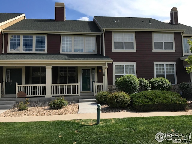 6608 W 3rd St Unit 35-58, Greeley, CO 80634 - townhome / multi-family property featuring a chimney, a porch, and a front lawn