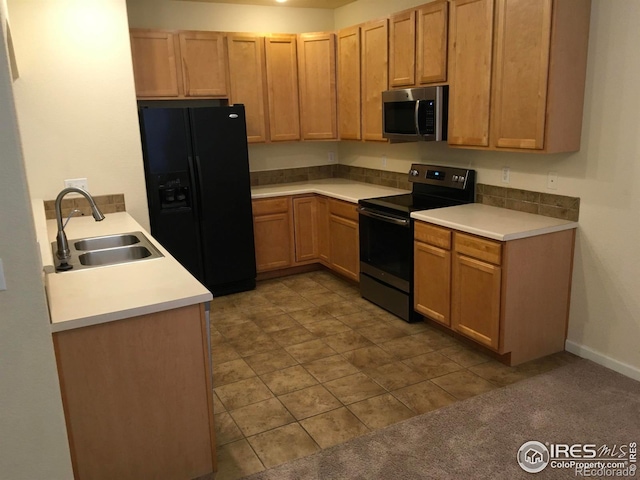 6608 W 3rd St Unit 35-58, Greeley, CO 80634 - kitchen with stainless steel appliances, a sink, light countertops, dark tile patterned floors, and baseboards