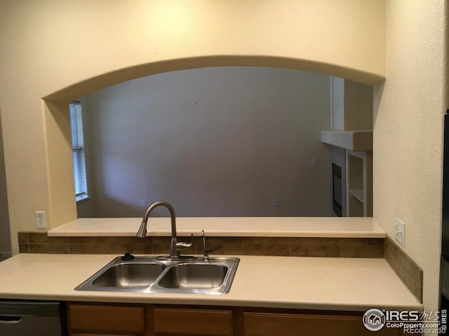 6608 W 3rd St Unit 35-58, Greeley, CO 80634 - kitchen featuring a sink, dishwashing machine, arched walkways, and light countertops
