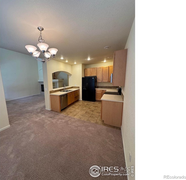 6608 W 3rd St Unit 35-58, Greeley, CO 80634 - kitchen with stainless steel appliances, a sink, light countertops, light colored carpet, and a chandelier
