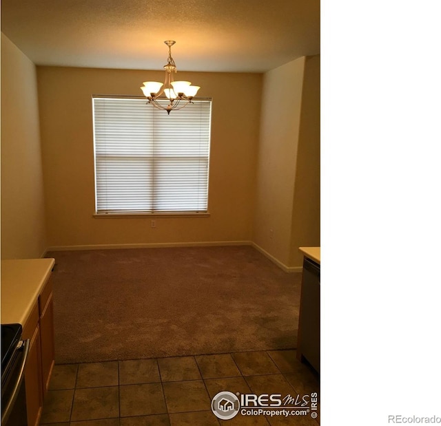 6608 W 3rd St Unit 35-58, Greeley, CO 80634 - unfurnished dining area featuring dark colored carpet, a chandelier, dark tile patterned flooring, and baseboards