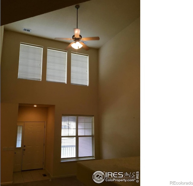 6608 W 3rd St Unit 35-58, Greeley, CO 80634 - tiled foyer featuring ceiling fan, baseboards, and a towering ceiling