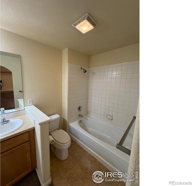 6608 W 3rd St Unit 35-58, Greeley, CO 80634 - full bath featuring toilet, tile patterned floors, vanity, bathing tub / shower combination, and a textured ceiling