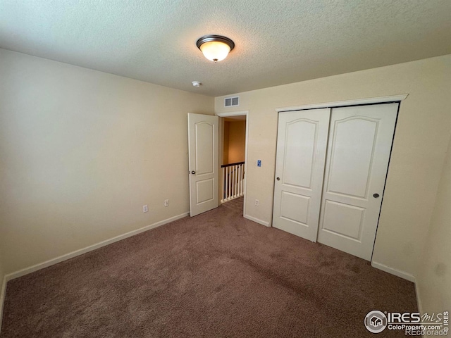 6608 W 3rd St Unit 35-58, Greeley, CO 80634 - unfurnished bedroom with carpet, a textured ceiling, baseboards, and a closet