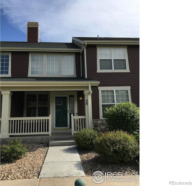 6608 W 3rd St Unit 35-58, Greeley, CO 80634 - view of front of house with a porch and a chimney