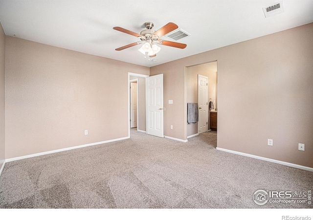 unfurnished bedroom featuring carpet floors, baseboards, connected bathroom, and a ceiling fan