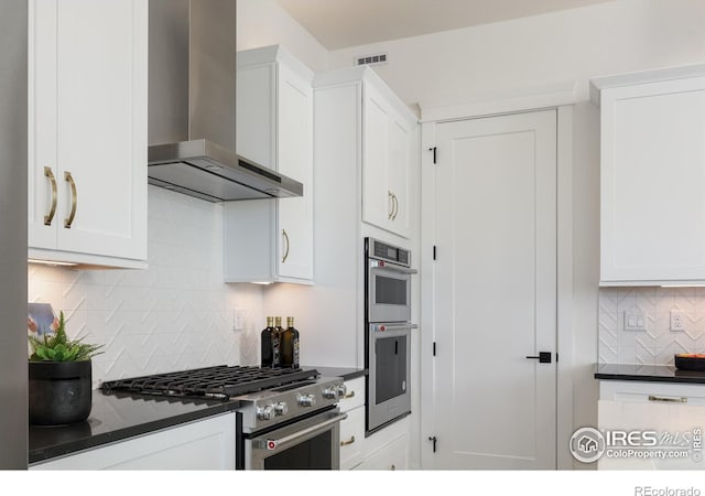 1611 Poplar Dr, Erie, CO 80516 - kitchen with wall chimney exhaust hood, stainless steel appliances, dark countertops, and backsplash