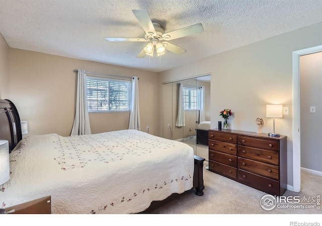 bedroom featuring a closet, carpet flooring, a ceiling fan, a textured ceiling, and baseboards