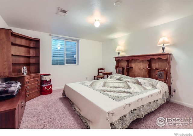 carpeted bedroom featuring baseboards